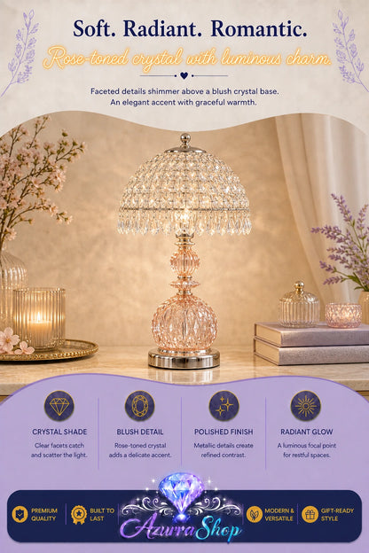 A rose-toned crystal table lamp with a faceted dome shade and metallic base, displayed on a tabletop in a styled interior scene. The image includes promotional text at the top and a purple banner at the bottom with feature callouts and the brand name Azurra Shop.