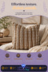 Chunky brown and cream woven throw pillow resting on a beige armchair with a knit blanket