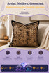 Black throw pillow with gold lace-patterned texture resting on a beige sofa