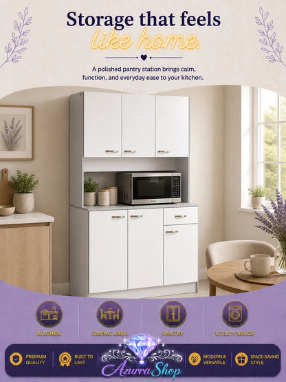 White kitchen pantry cabinet with an integrated microwave shelf, styled in a bright kitchen with a small side table.
