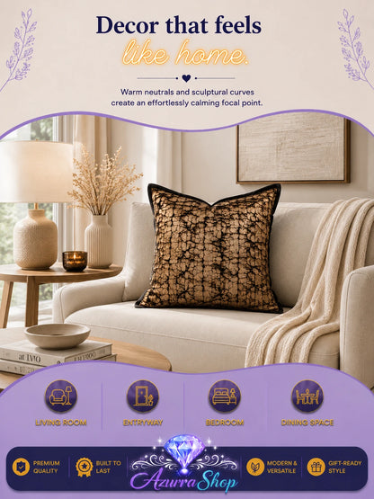 Black and gold lace-patterned throw pillow styled on a cream armchair in a modern living room