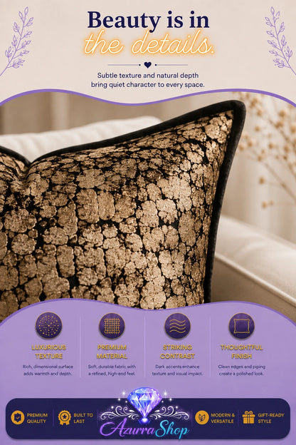 Close-up of the black and gold lace-patterned texture on the throw pillow