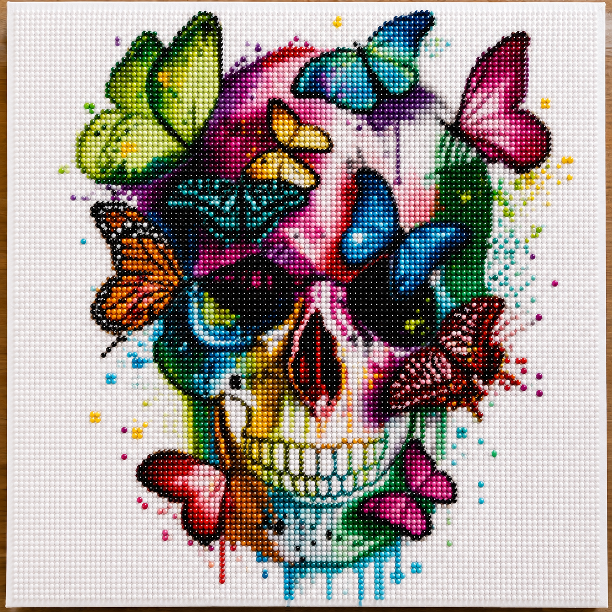 Colorful Butterfly Skull Diamond Painting Kit – completed 5D diamond art featuring a vibrant rainbow skull surrounded by colorful butterflies with paint drip effect on white canvas
