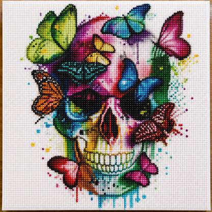 Colorful Butterfly Skull Diamond Painting Kit – completed 5D diamond art featuring a vibrant rainbow skull surrounded by colorful butterflies with paint drip effect on white canvas
