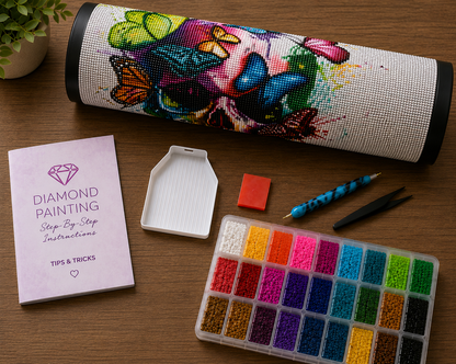 Colorful Butterfly Skull Diamond Painting Kit – flat lay of kit contents including rolled canvas, 24-color diamond drill container, grooved sorting tray, wax pad, applicator pen, tweezers, and step-by-step instruction booklet with tips and tricks
