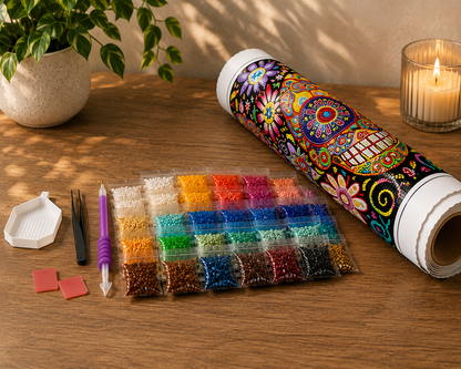 Rainbow Mandala Sugar Skull Diamond Painting Kit – flat lay of kit contents including rolled canvas in tube packaging, 30-color resealable diamond drill bags, grooved sorting tray, applicator pen, tweezers, and two wax pads on a warm wood surface
