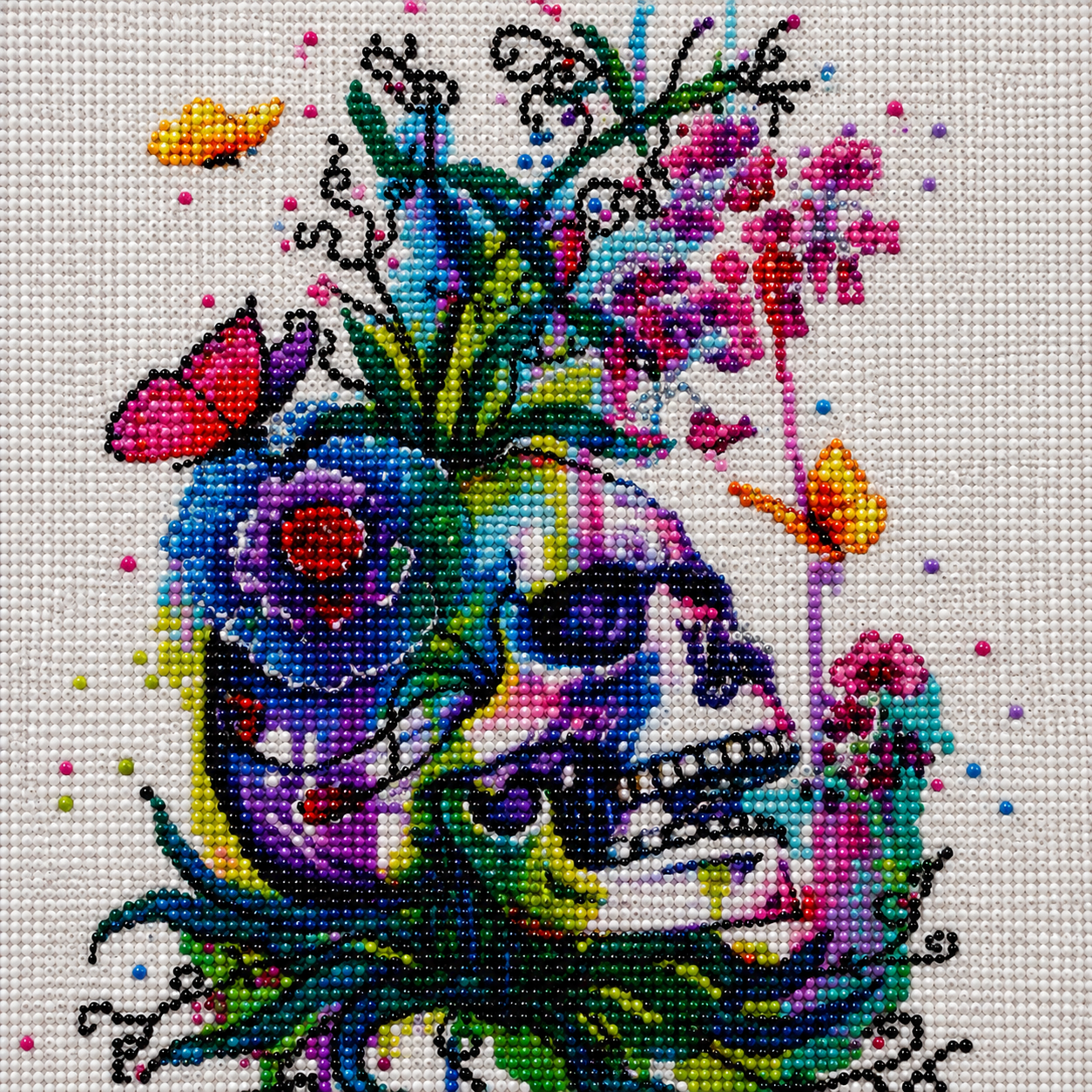 Watercolor Skull with Wildflowers Diamond Painting Kit – completed  diamond art featuring a vibrant watercolor-style skull bursting with colorful wildflowers, butterflies, and botanical details on a white canvas
