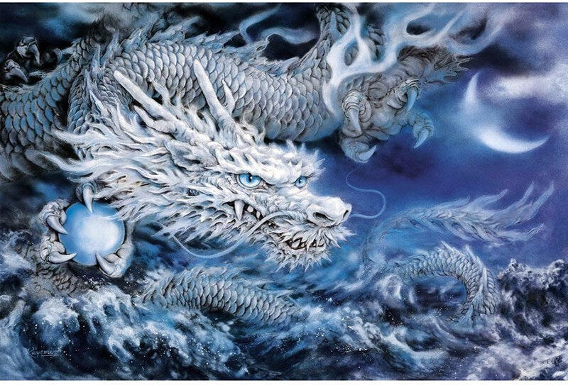 Finished arctic dragon diamond painting with a white and silver dragon holding a glowing orb over moonlit ocean waves | Azurra Shop