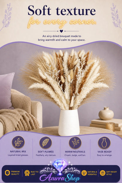 Promotional graphic showing a large dried pampas grass bouquet in warm neutral tones, arranged in a white ceramic vase on a wooden side table next to a cream sofa