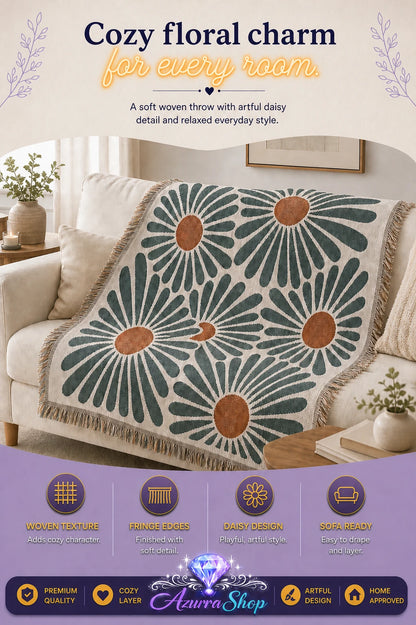 Daisy pattern woven throw blanket with fringe edges draped over a cream sofa in a living room