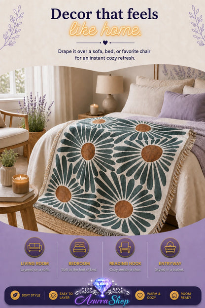 Daisy pattern throw blanket draped across a bed with pillows and a bedside lamp