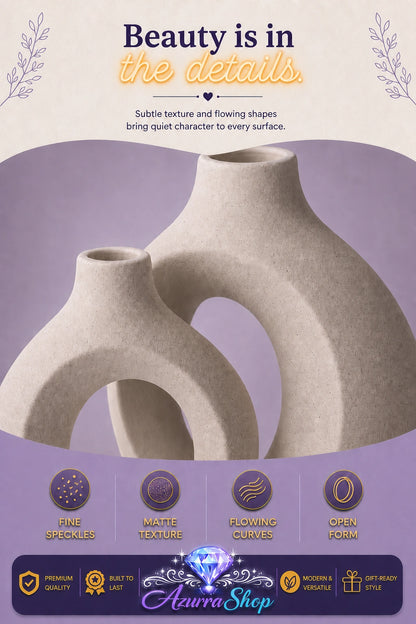 Close up of the entwined ceramic vases showing their fine speckled texture and matte finish