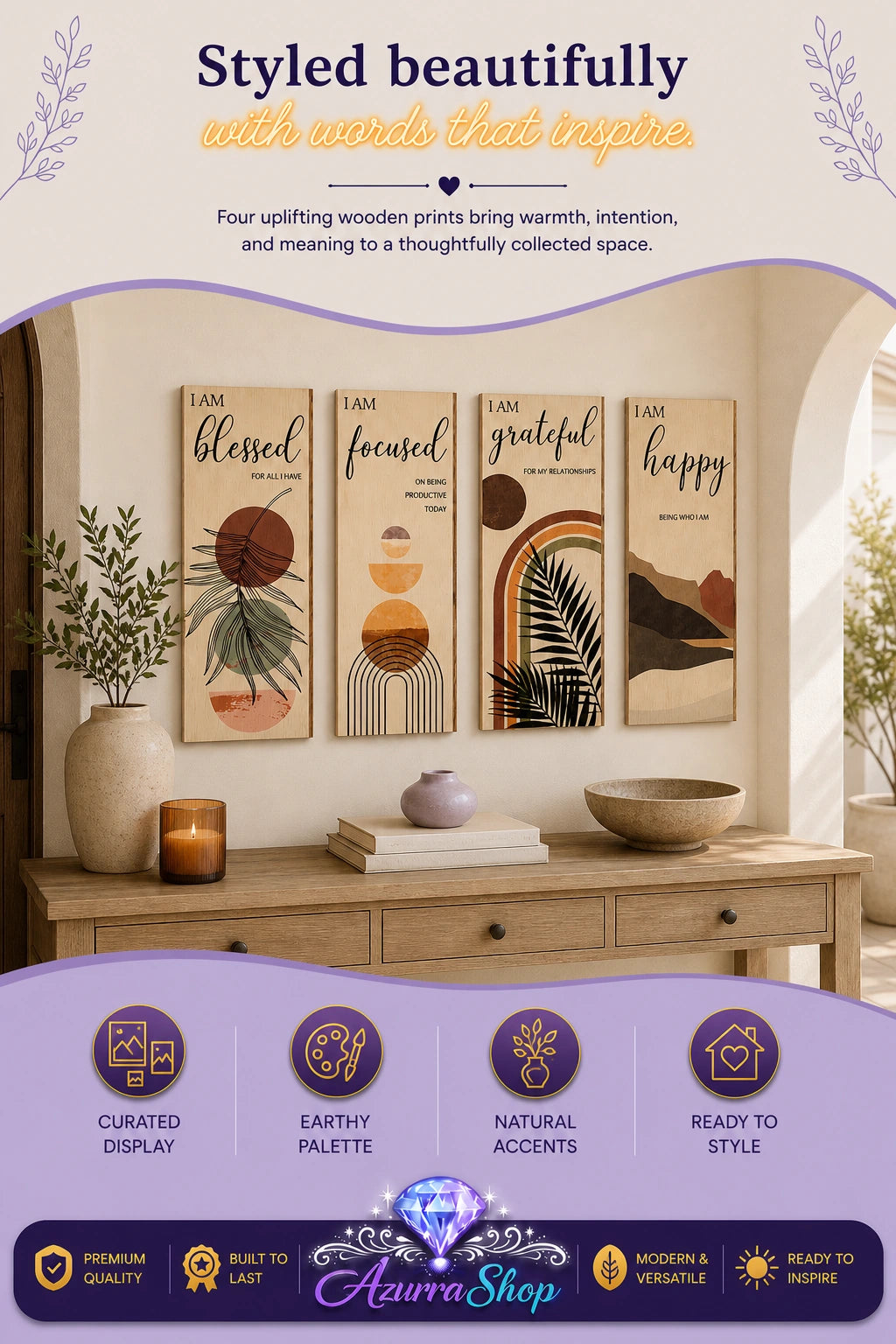 Four vertical wooden wall art panels reading "blessed," "focused," "grateful," and "happy" in black script, each with an abstract earth-toned pattern, displayed above a wooden console table with a vase of greenery, a candle, and stacked books in an entryway.