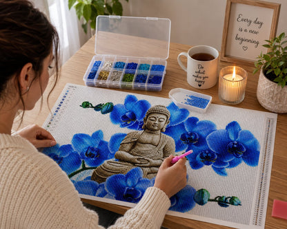 Working on the Buddha in blue orchid bloom kit at a cozy desk