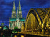 Finished Cologne Cathedral diamond painting kit artwork with the twin Gothic spires lit up at night above the golden bridge and river | Azurra Shop