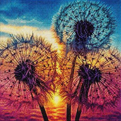 Finished dandelion rainbow sunset diamond painting with three dandelion seed heads glowing against an orange and pink sunset sky | Azurra Shop