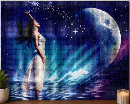 Finished ethereal moon goddess diamond painting with a woman in a flowing white dress reaching toward a glowing blue moon | Azurra Shop