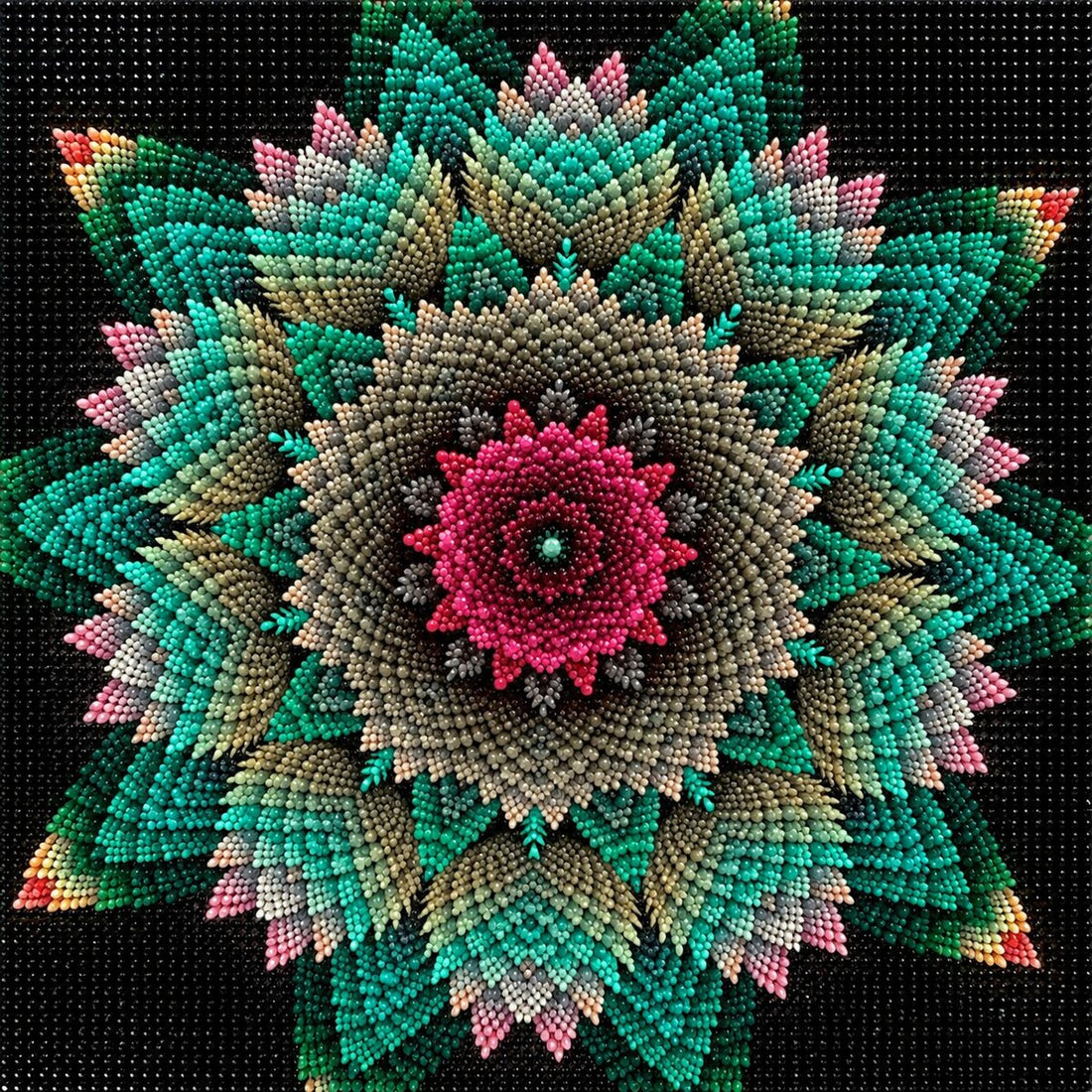 Finished floral star mandala diamond painting with a pink flower center and teal star petals on black | Azurra Shop