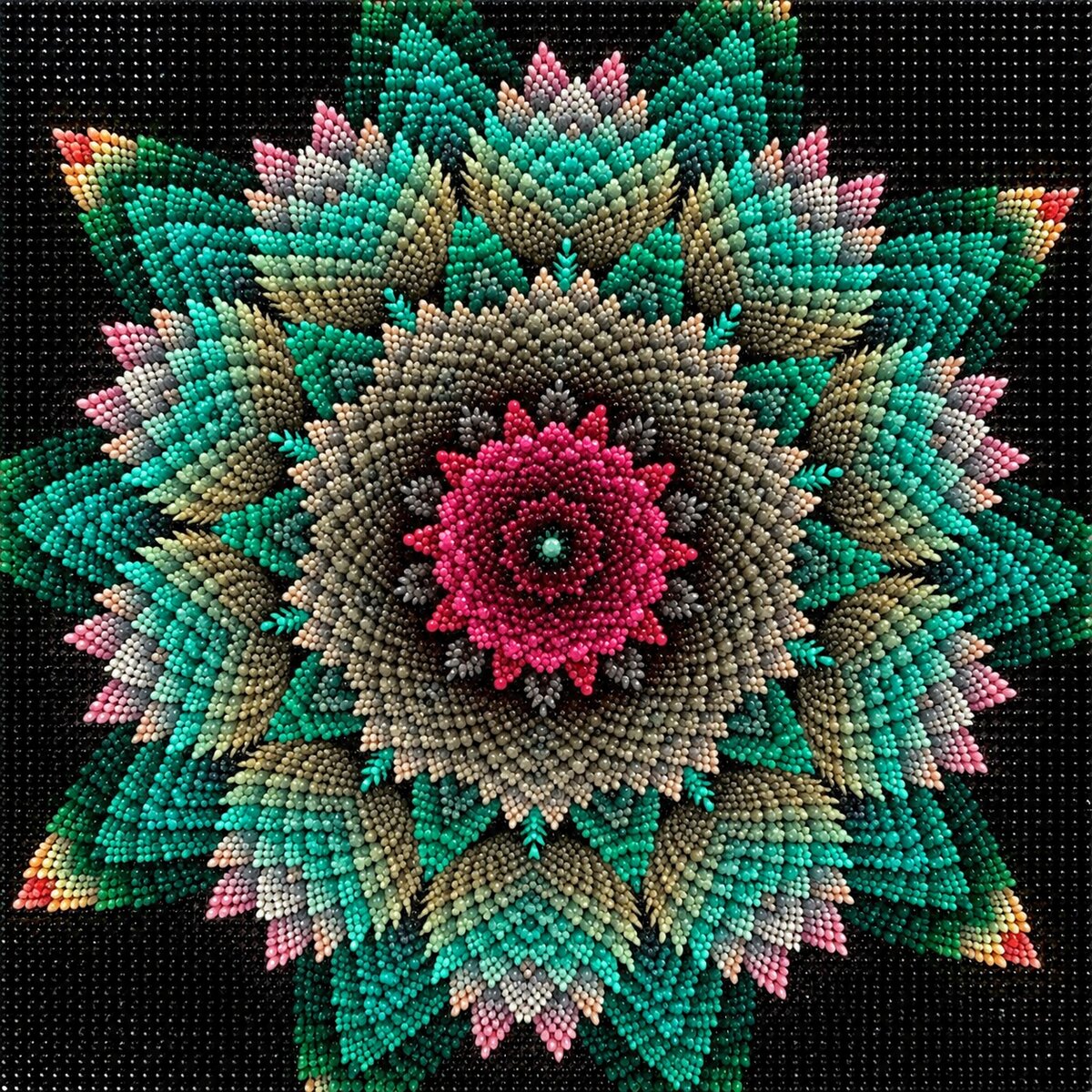 Finished floral star mandala diamond painting with a pink flower center and teal star petals on black | Azurra Shop