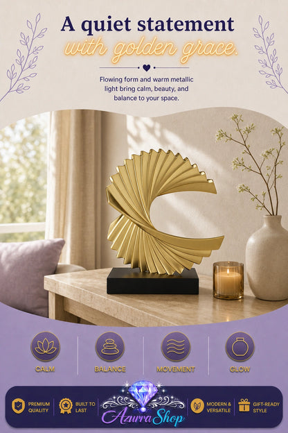 A gold metallic abstract fan-shaped sculpture on a black rectangular base, displayed on a wooden table in a softly lit room with a votive candle and a vase nearby. The image includes promotional text at the top and a purple footer with feature icons and the brand name "Azurra Shop".