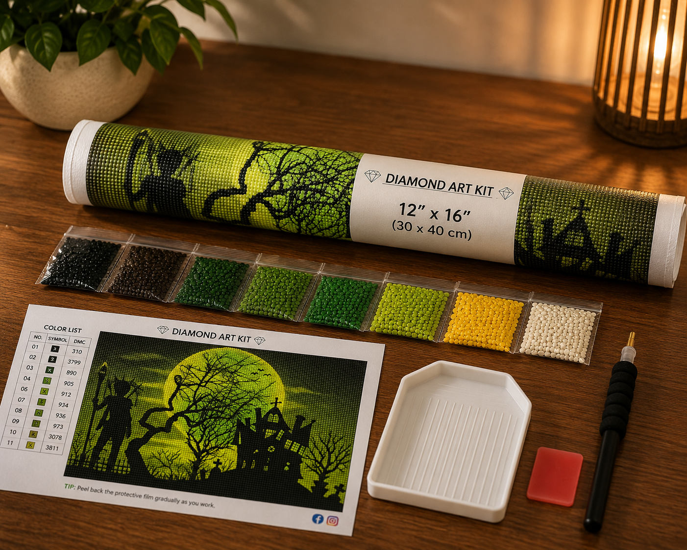 Headless Horseman &amp; Haunted Graveyard Diamond Painting Kit – flat lay on warm wood surface showing canvas rolled in a Diamond Art Kit tube labeled 12"x16" (30x40cm), 11-color strip of resealable diamond drill bags in black, dark brown, dark green, medium green, bright green, yellow-green, yellow, and white tones, white grooved sorting tray, black applicator pen, red wax pad, and DMC color chart reference card with tip to peel back protective film gradually

