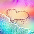 Close up of the finished rainbow heart in the sand diamond painting with waves washing up on shore | Azurra Shop