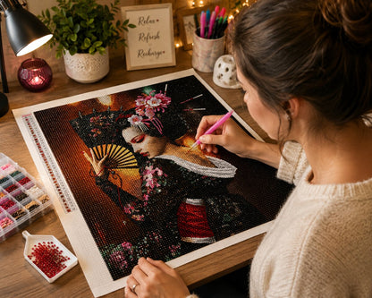 Working on the Japanese geisha kit at a desk with string lights, a candle, and diamond trays nearby | Azurra Shop