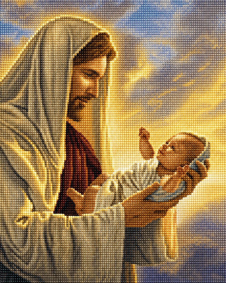 Close up of the finished diamond painting of Jesus holding a newborn baby, in warm golden light