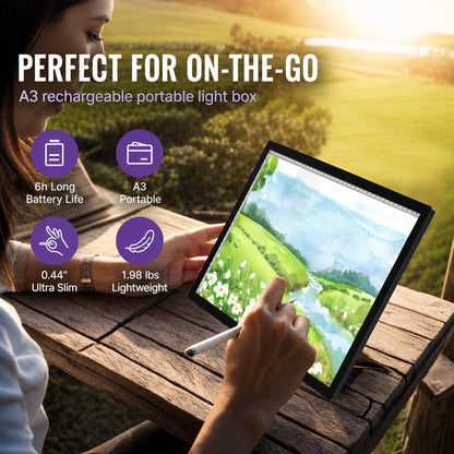 Woman using the A3 LED light pad outdoors on a wooden table