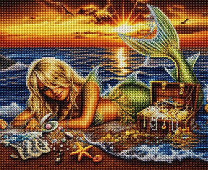 Finished mermaid and treasure chest diamond painting with a blonde mermaid lying on the beach beside jewels and a treasure chest at sunset | Azurra Shop