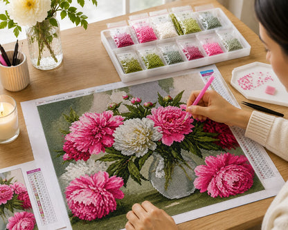 Working on the pink peony bouquet kit at a desk with a candle and fresh flowers nearby | Azurra Shop
