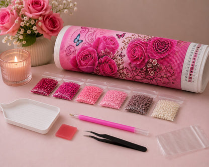 Rolled canvas and full supplies for the pink rose garden kit, including diamond bags, applicator pen, and tweezers | Azurra Shop