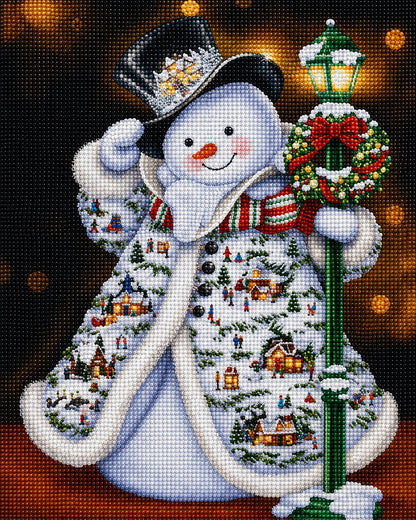 Close up of the finished snowman diamond painting wearing a coat with a Christmas village scene and holding a lamppost | Azurra Shop