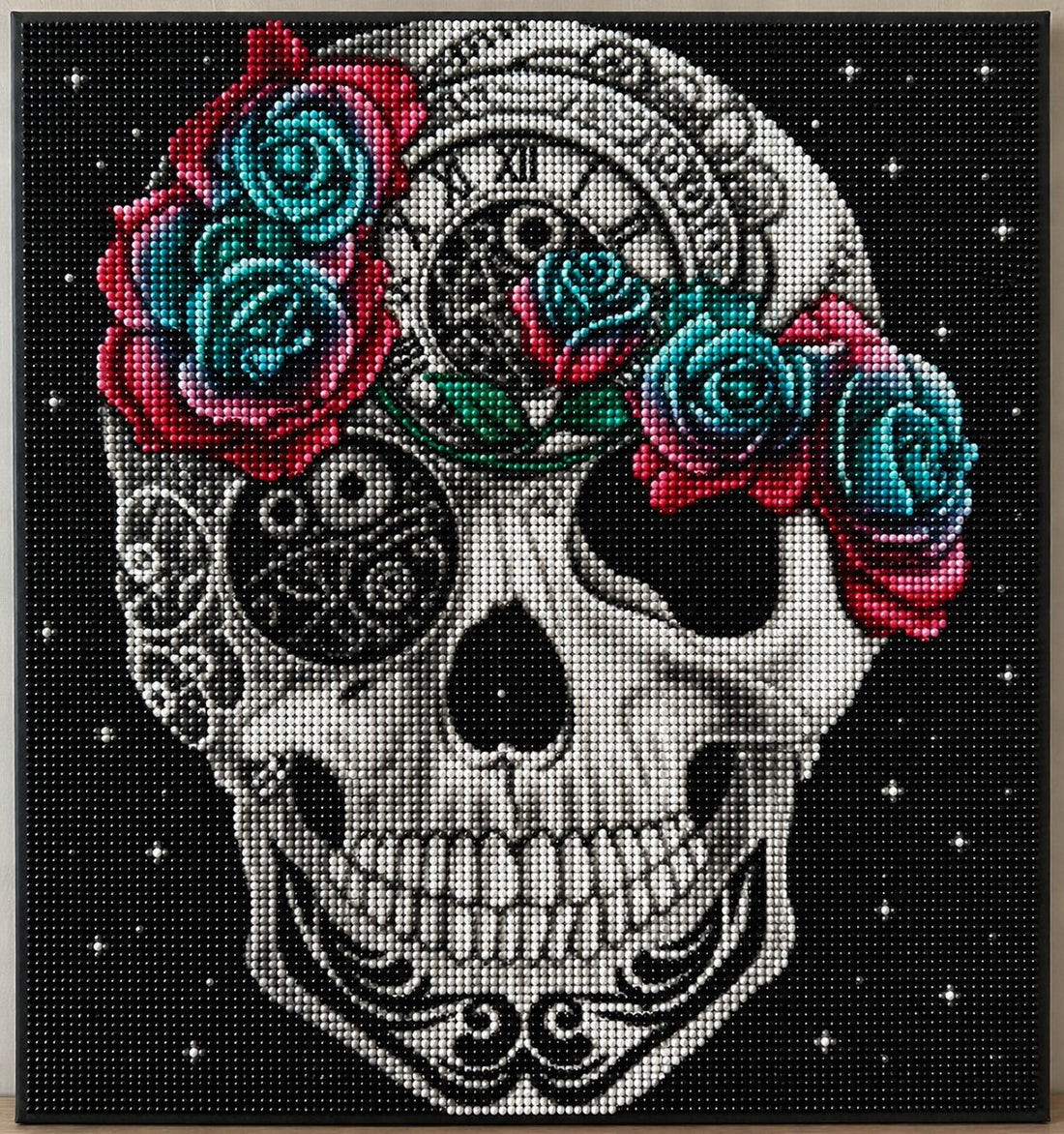 Close up of the finished steampunk sugar skull diamond painting with clock gears and teal and red roses | Azurra Shop