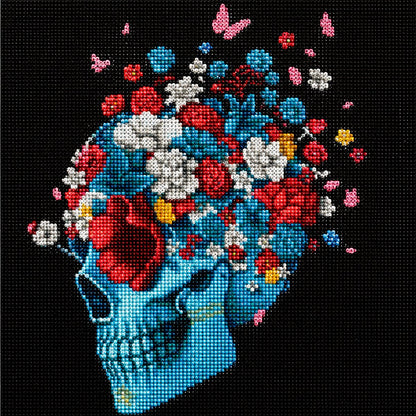 Close up of the finished teal skull diamond painting covered in blue, white, red, and pink flowers and butterflies | Azurra Shop