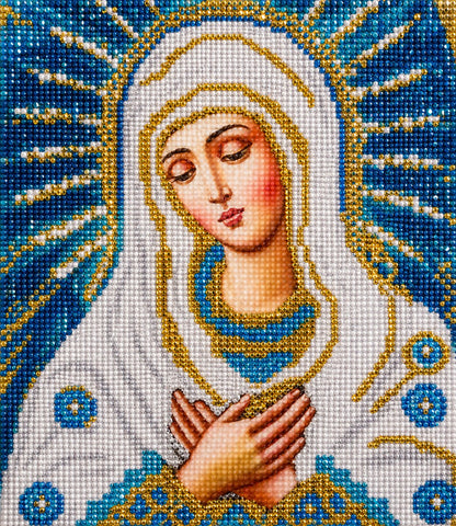 Close up of the finished Our Lady of Tenderness diamond painting, hands clasped in prayer with a golden halo and blue mandorla