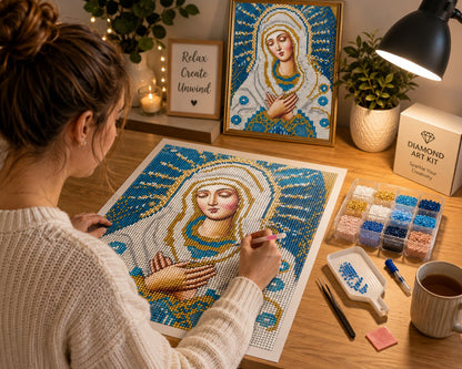 Working on the Our Lady of Tenderness kit at a cozy desk with warm lighting