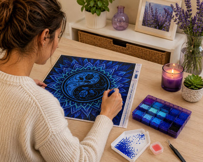 Woman placing diamonds on the blue yin yang lotus mandala canvas at a desk with lavender and a candle | Azurra Shop